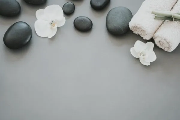 Heated massage stones with orchid and towels
